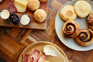 a wooden table topped with plates of food