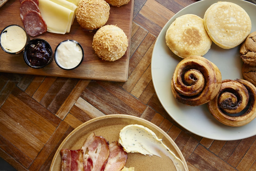 a wooden table topped with plates of food