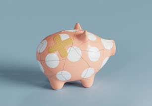 a pink piggy bank with a cross painted on it
