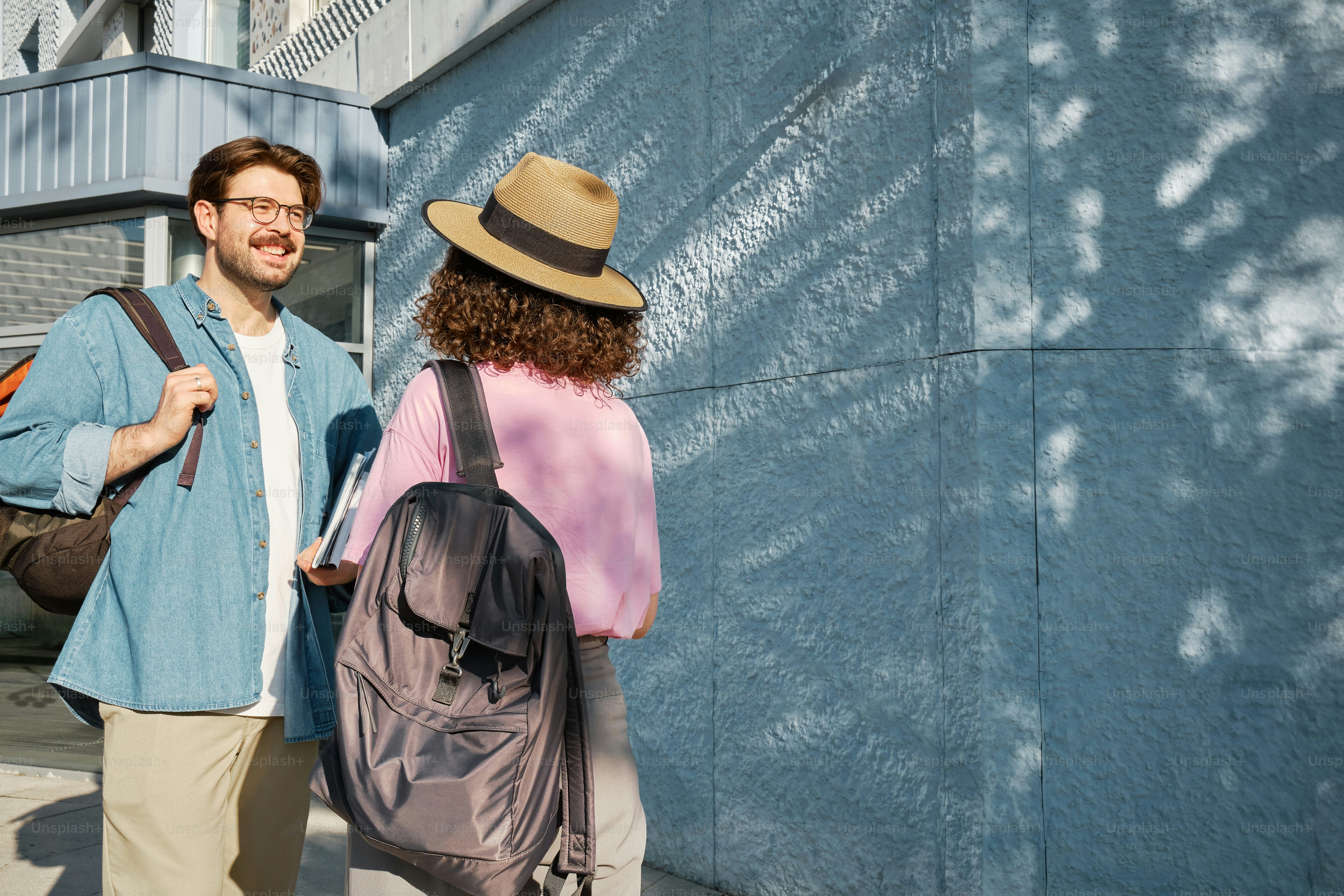 A man and a woman standing next to each other photo – Books Image on ...