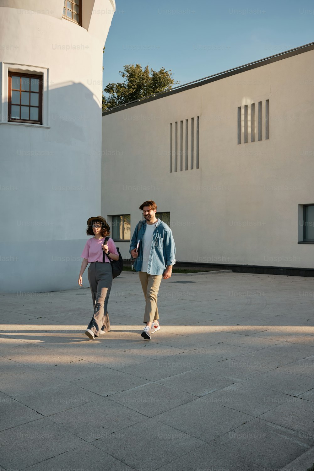a man and a woman walking in a courtyard