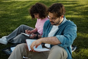 a man and a little girl sitting on the grass