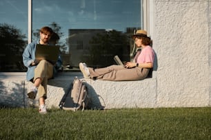 a couple of people sitting on a window sill