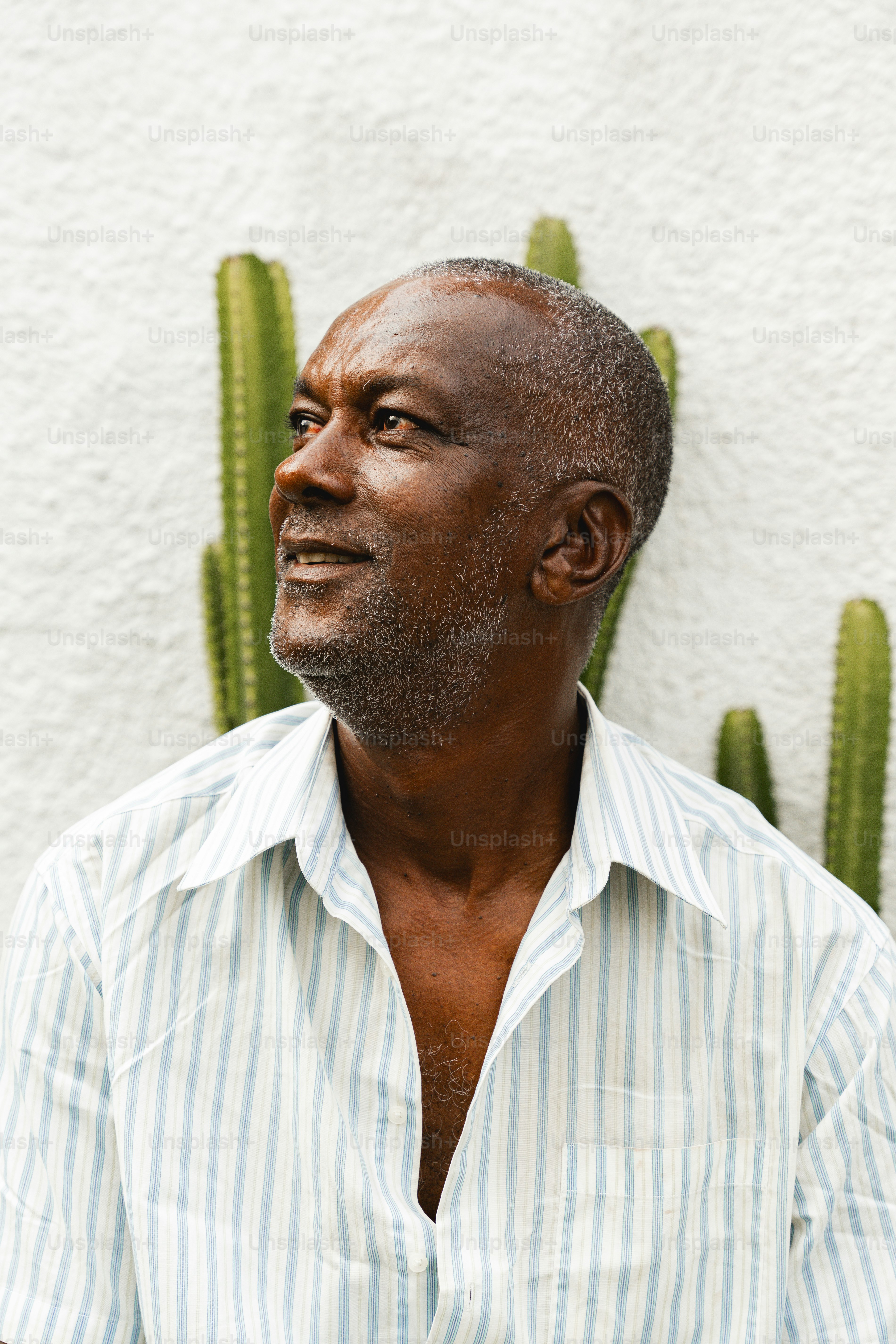a man standing in front of a cactus