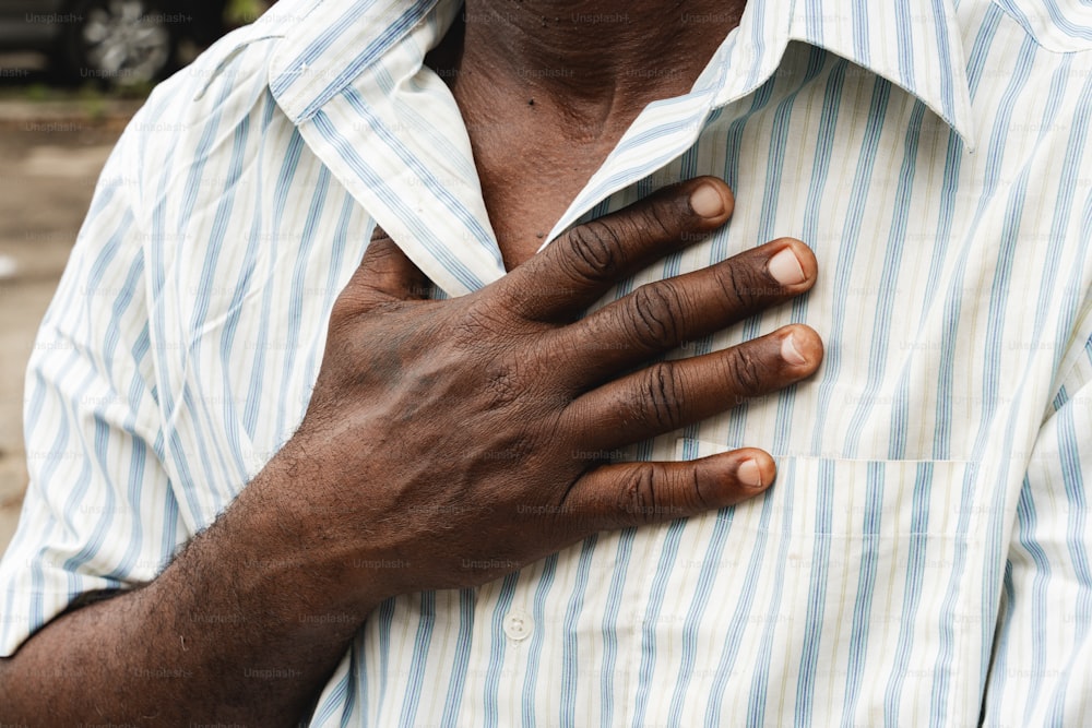 a close up of a person holding his chest