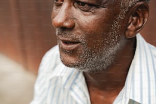 a close up of a person wearing a striped shirt