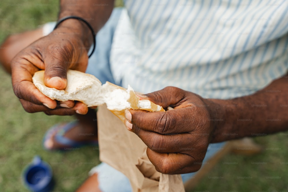 a man holding a piece of bread in his hands