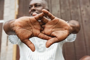 a man holding out his hands in front of his face