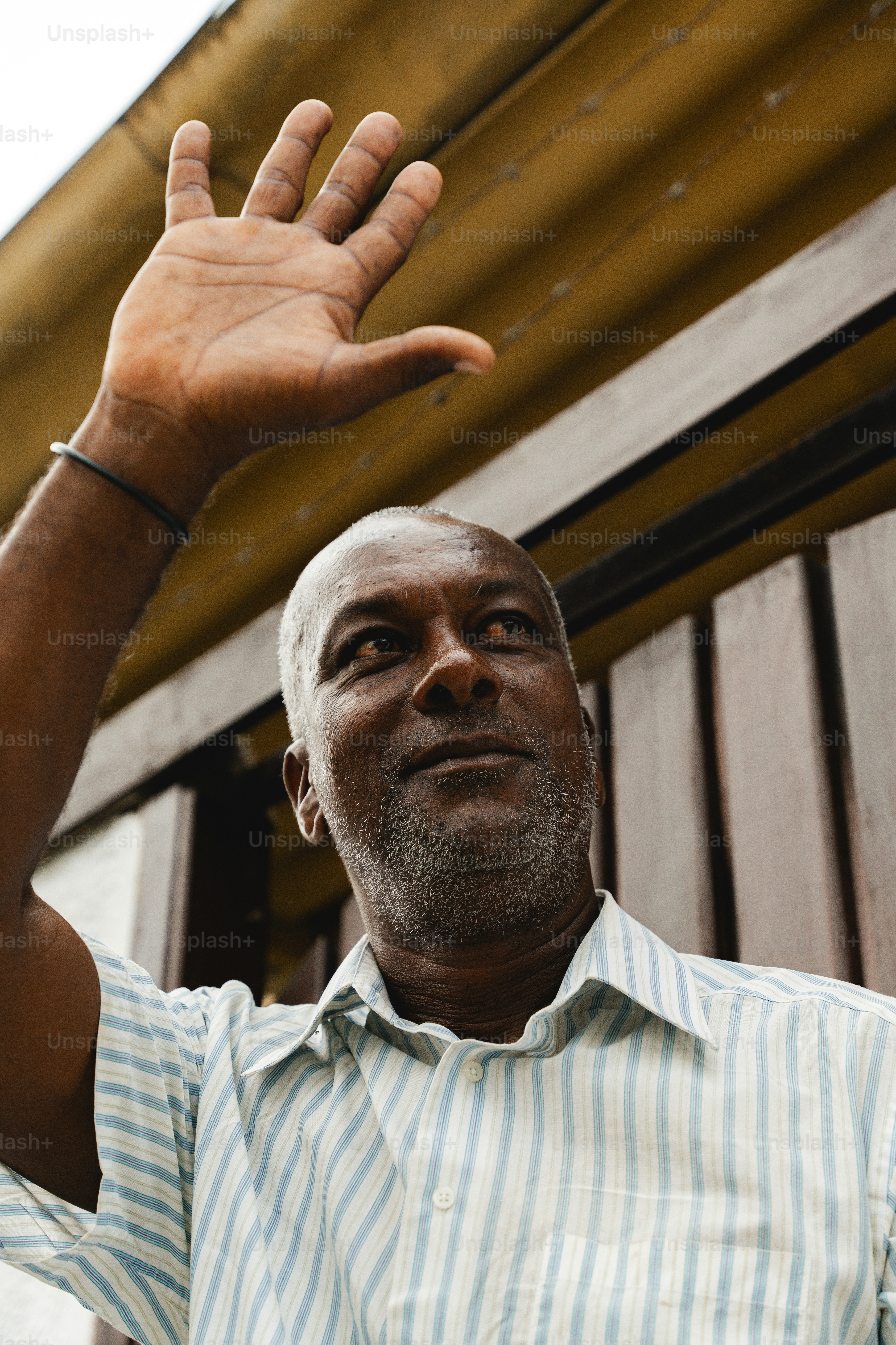 a man holding his hand up in the air