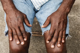 a man with his hands on his knees