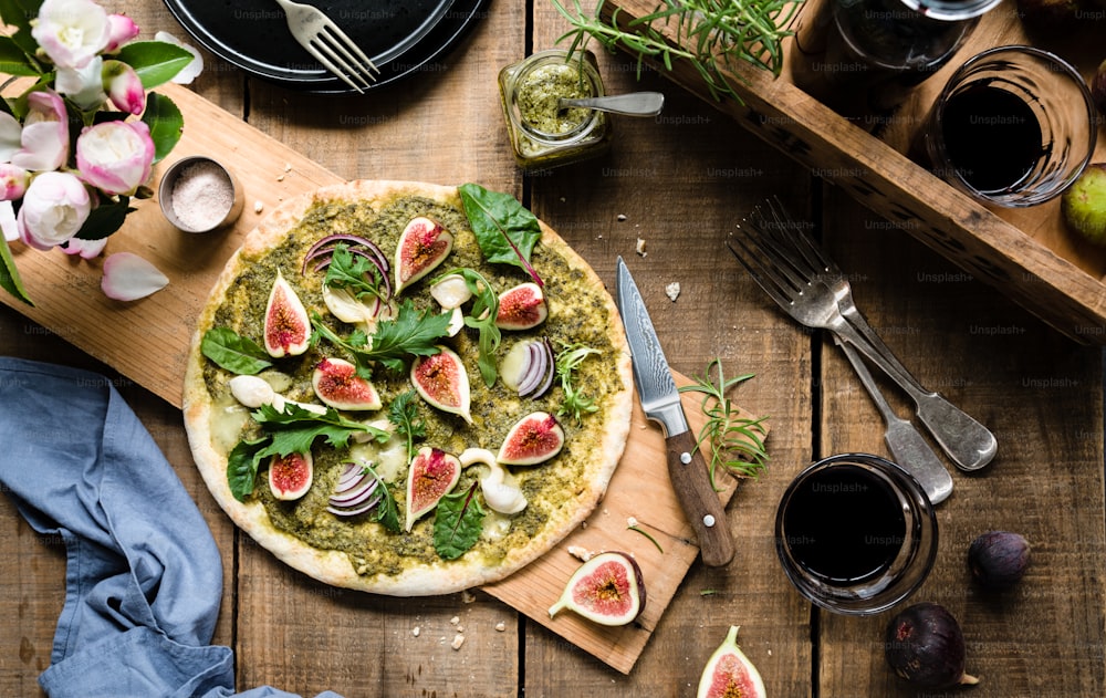 a pizza sitting on top of a wooden cutting board