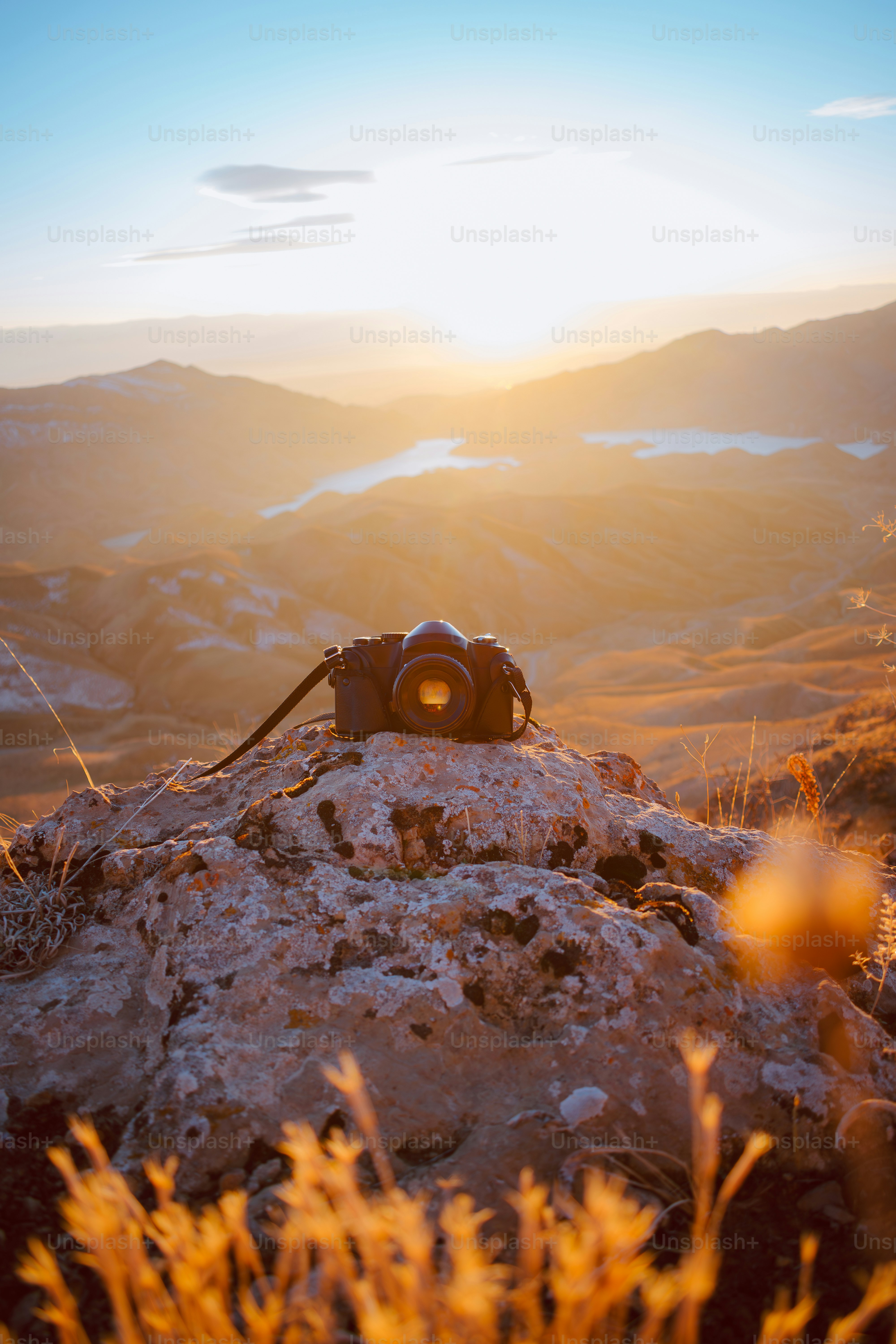 a camera sitting on top of a large rock