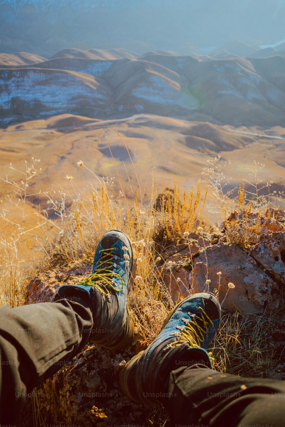 a pair of feet resting on top of a mountain