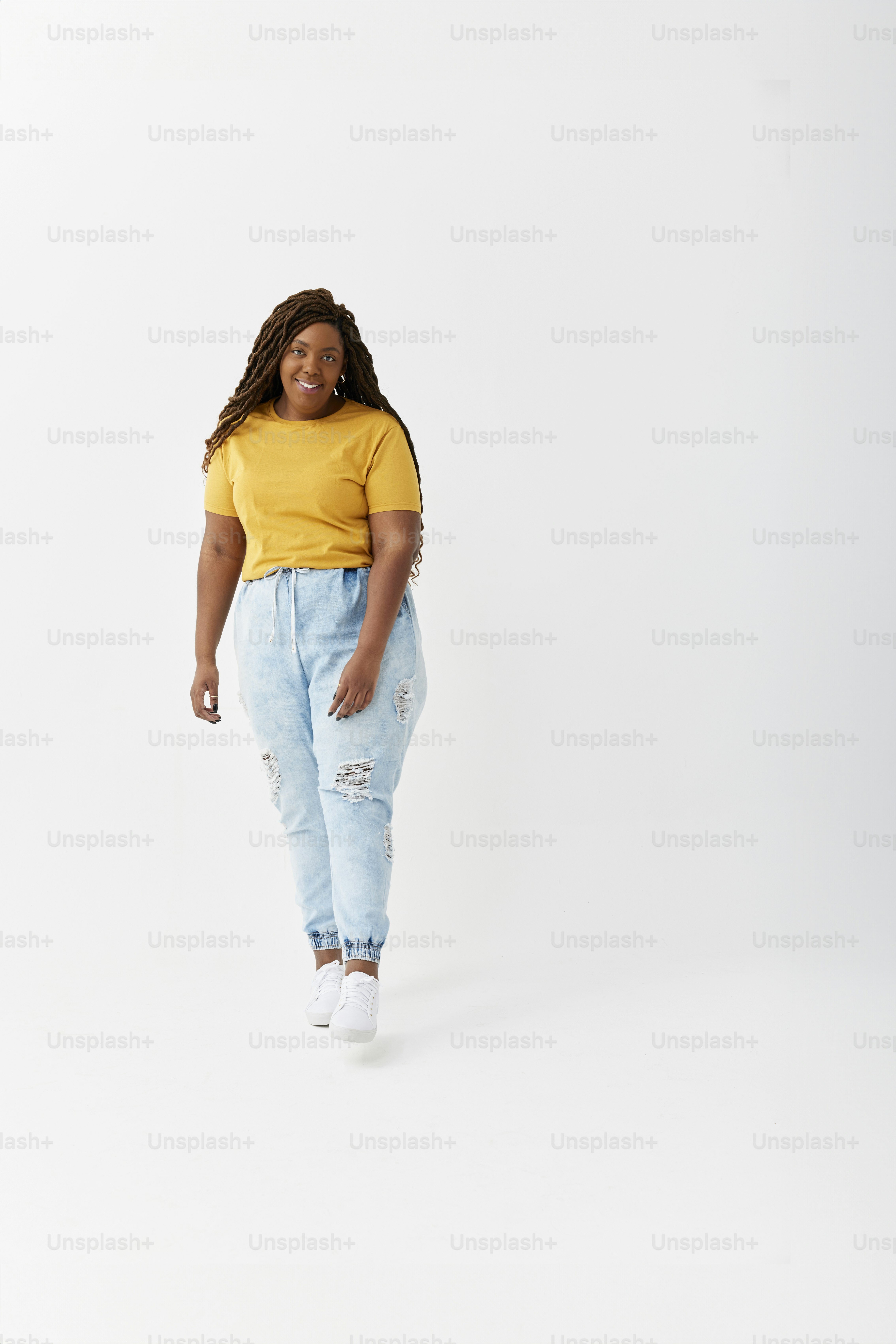 A woman in a yellow shirt and blue jeans photo – Girl Image on Unsplash