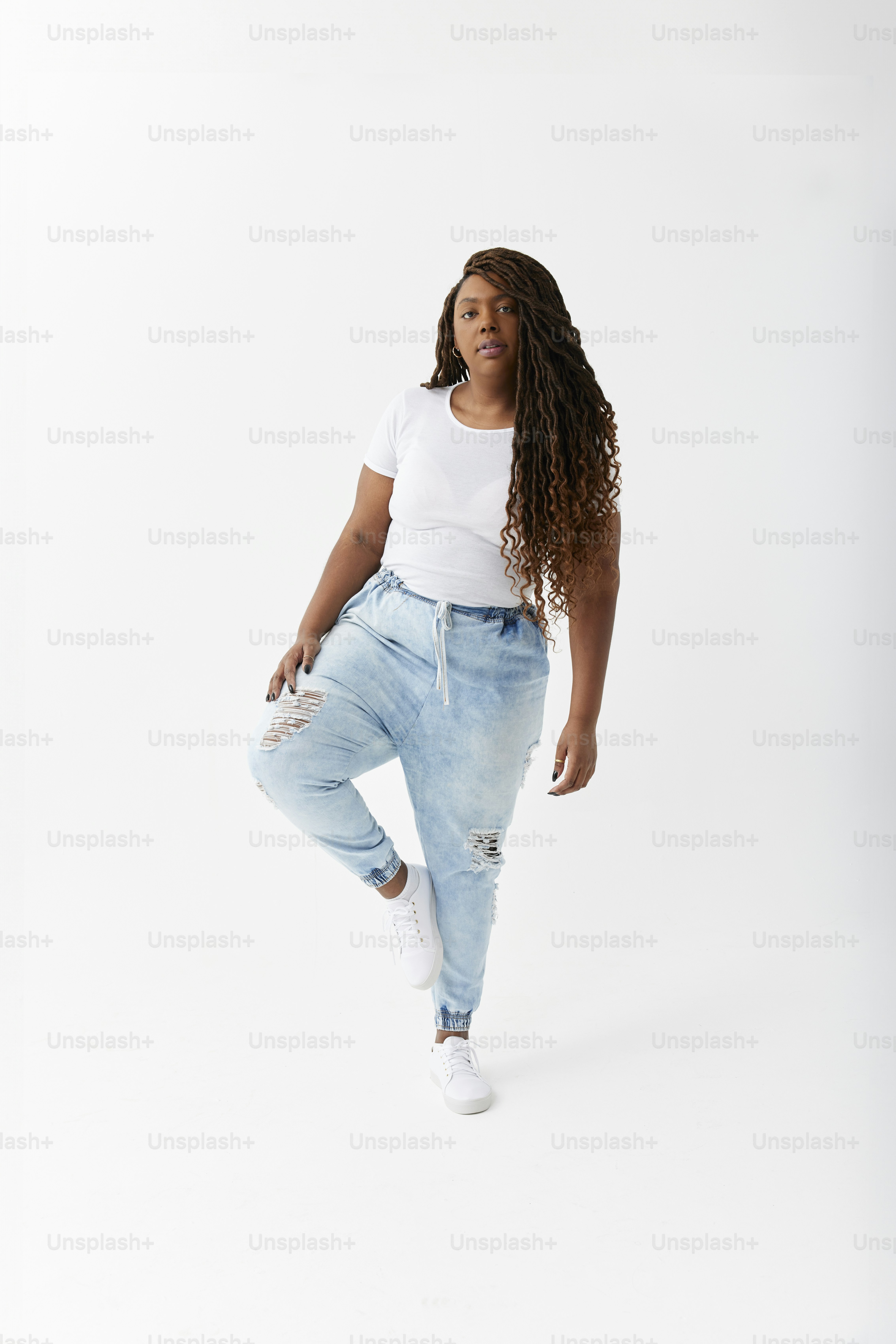 A woman in a white shirt is posing for a picture photo – Style Image on ...