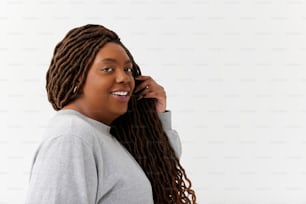 a woman with dreadlocks talking on a cell phone