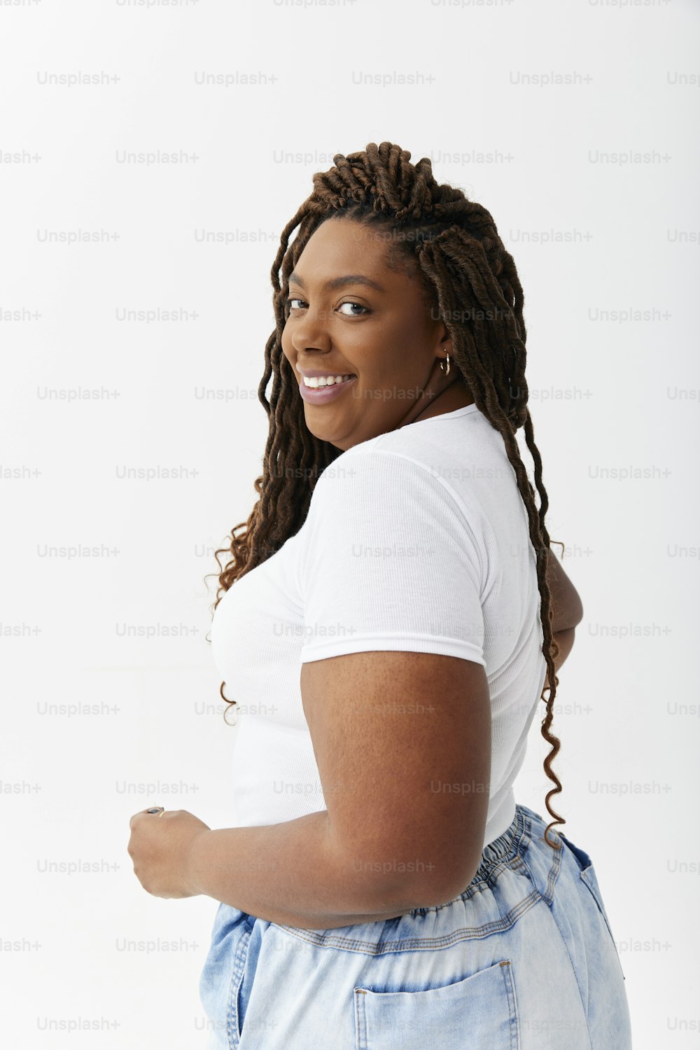 a woman with dreadlocks and a white t - shirt