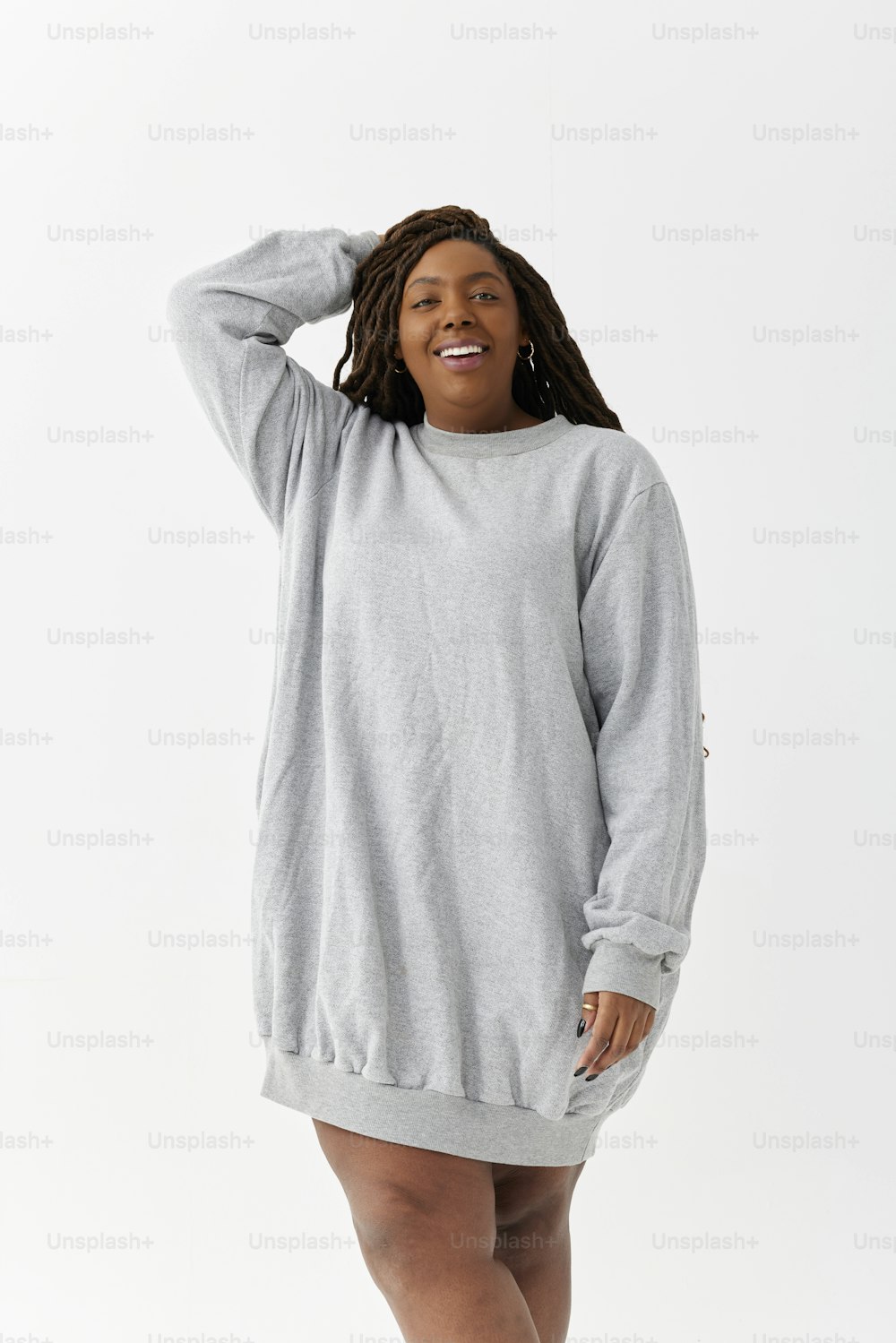 a woman in a grey sweatshirt dress
