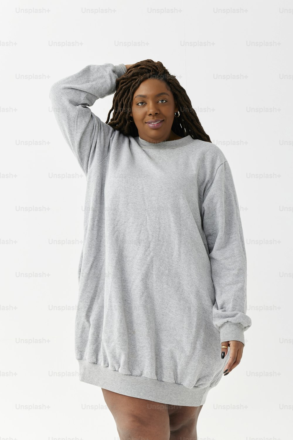 a woman in a grey sweatshirt dress