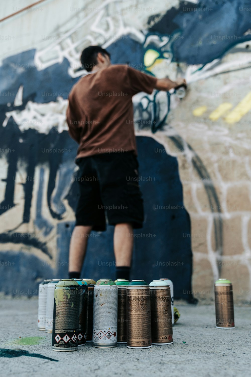 a man standing next to cans of beer