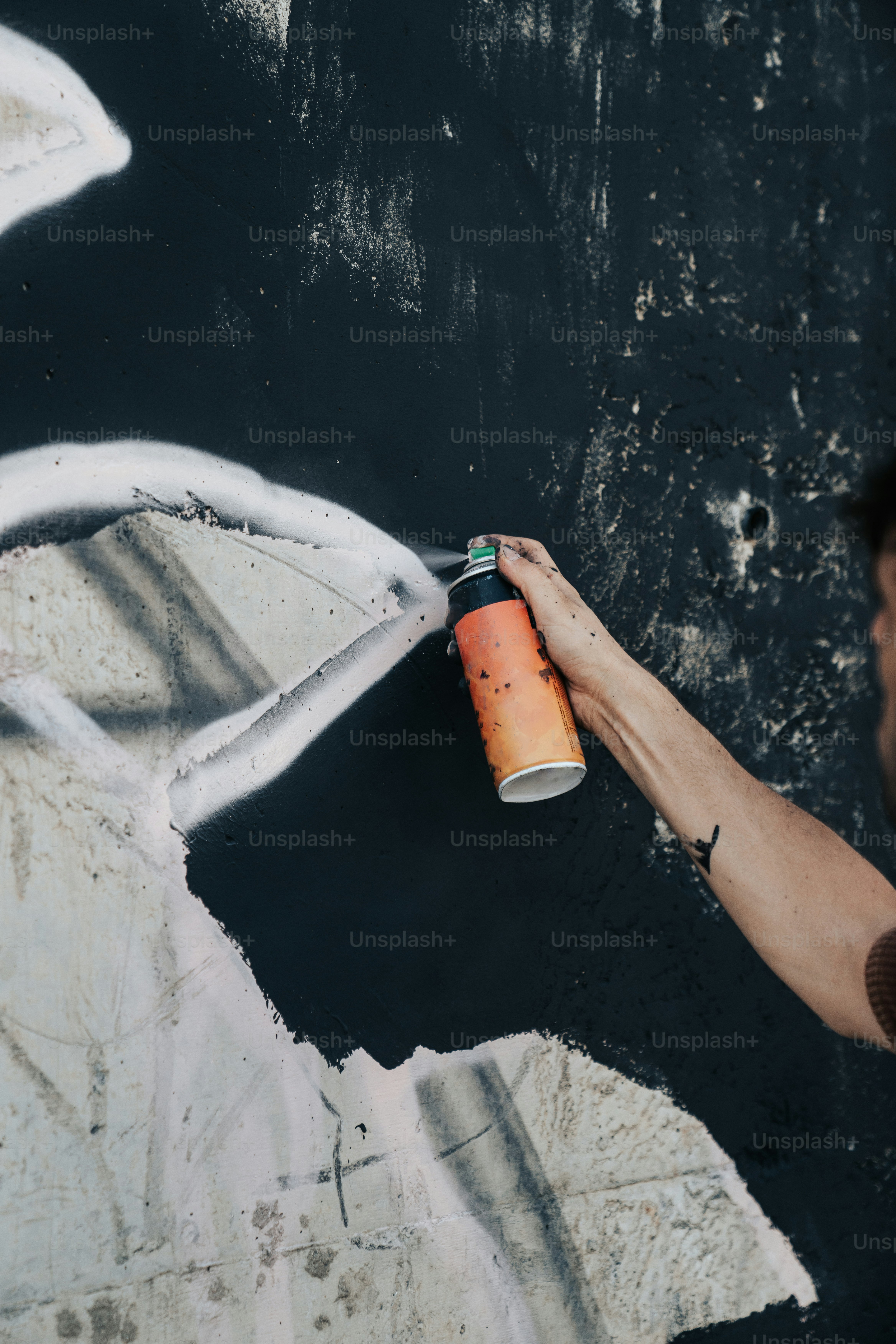 a man is painting a wall with white paint