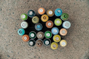 a group of cans sitting on top of a cement floor