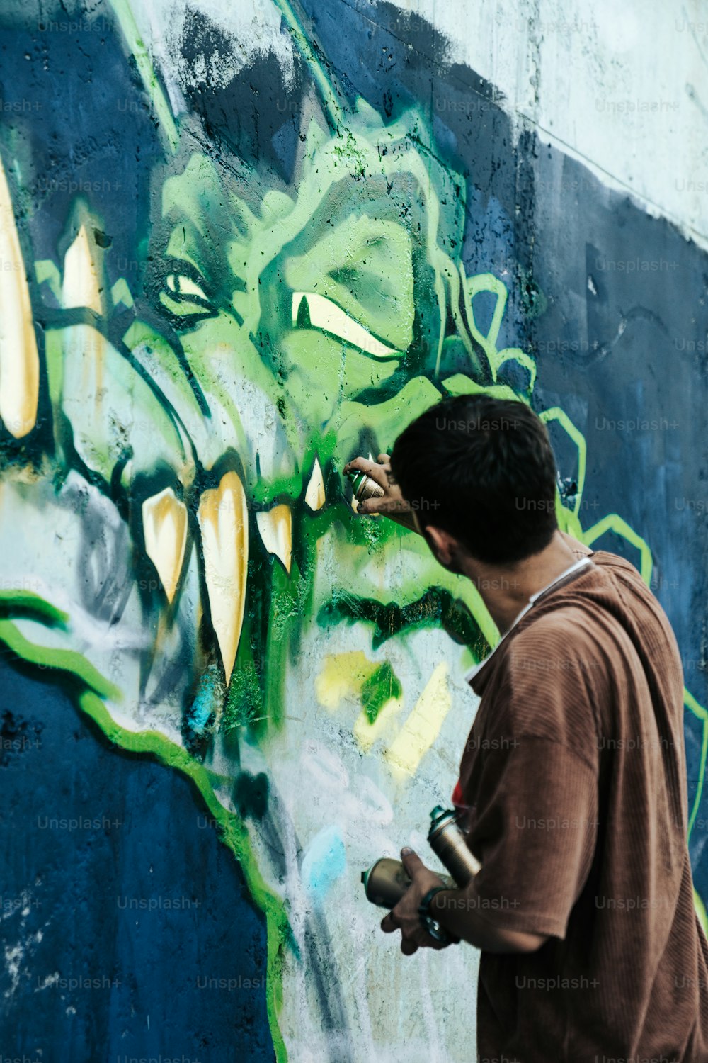 a man painting graffiti on a wall