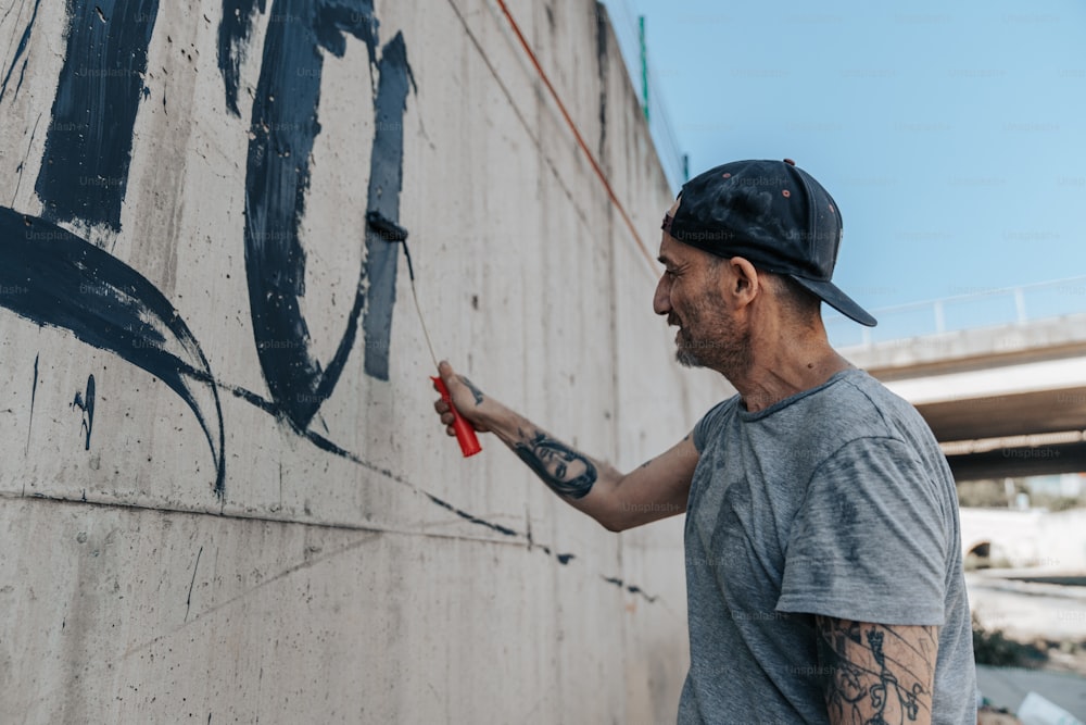a man holding a pair of scissors near a wall