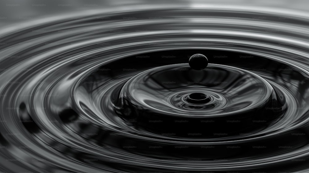 a black and white photo of a water drop