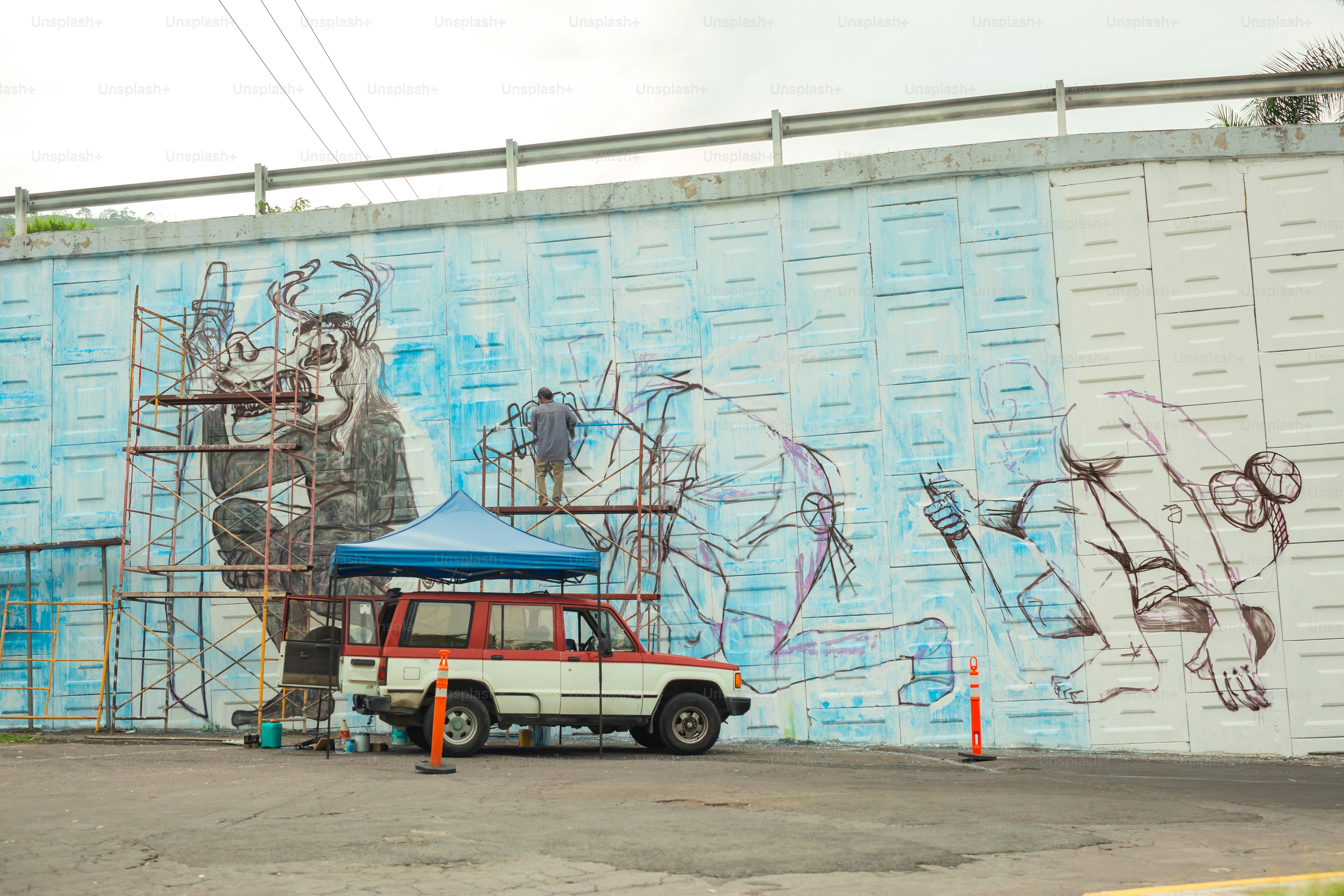 a white truck parked in front of a blue wall