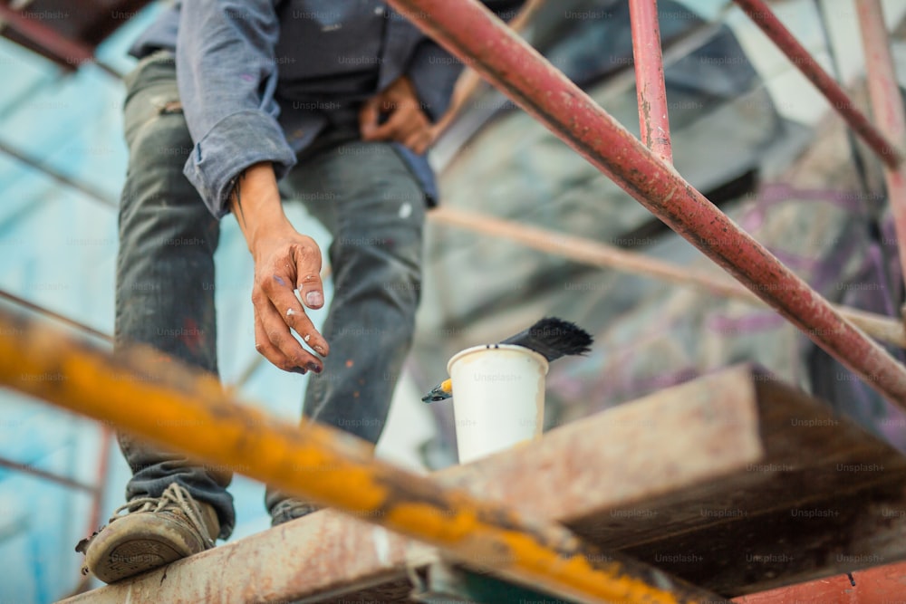 a small bird sitting on top of a metal pipe