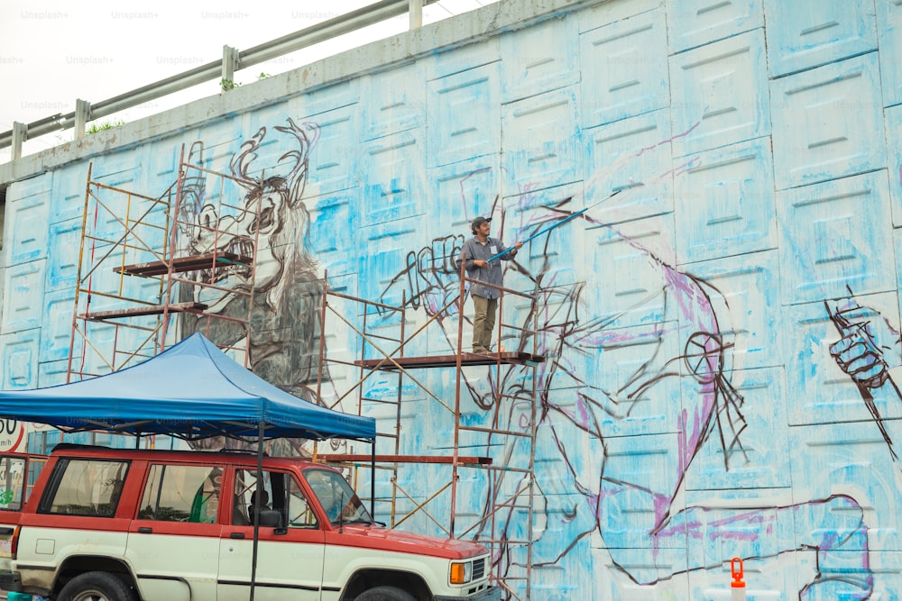 a truck parked in front of a building with scaffolding on it