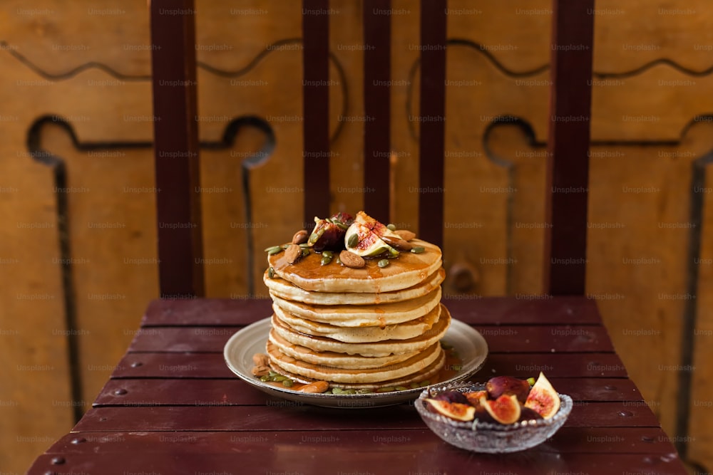 a stack of pancakes sitting on top of a wooden table