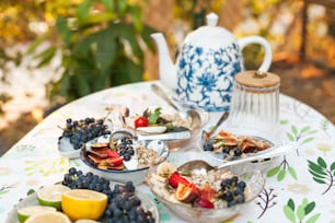 a table topped with plates of food and a tea pot