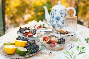 a table topped with plates of food and fruit
