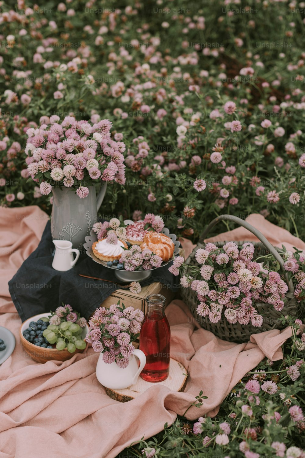 a table topped with flowers and plates of food