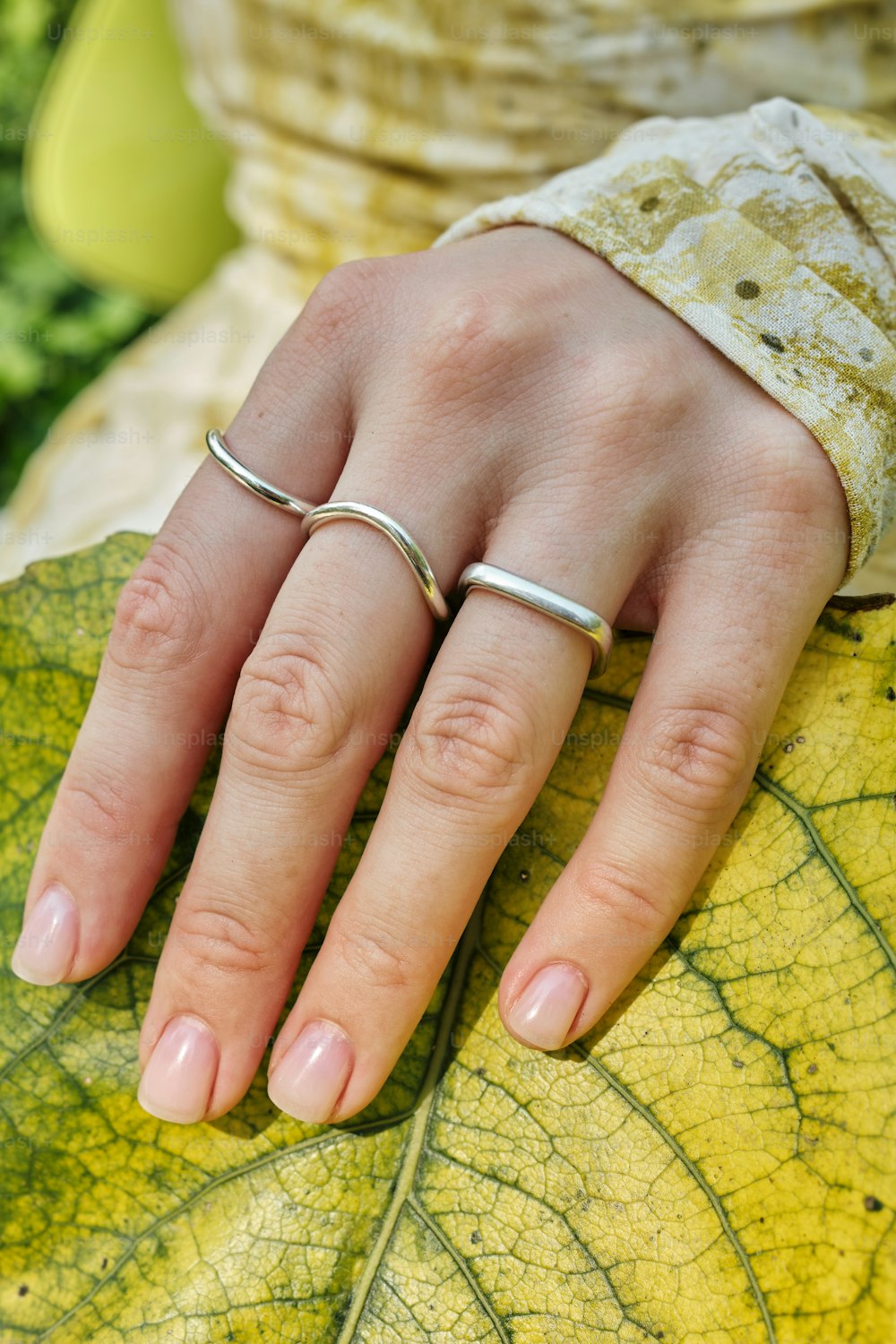 a close up of a person's hand on a leaf