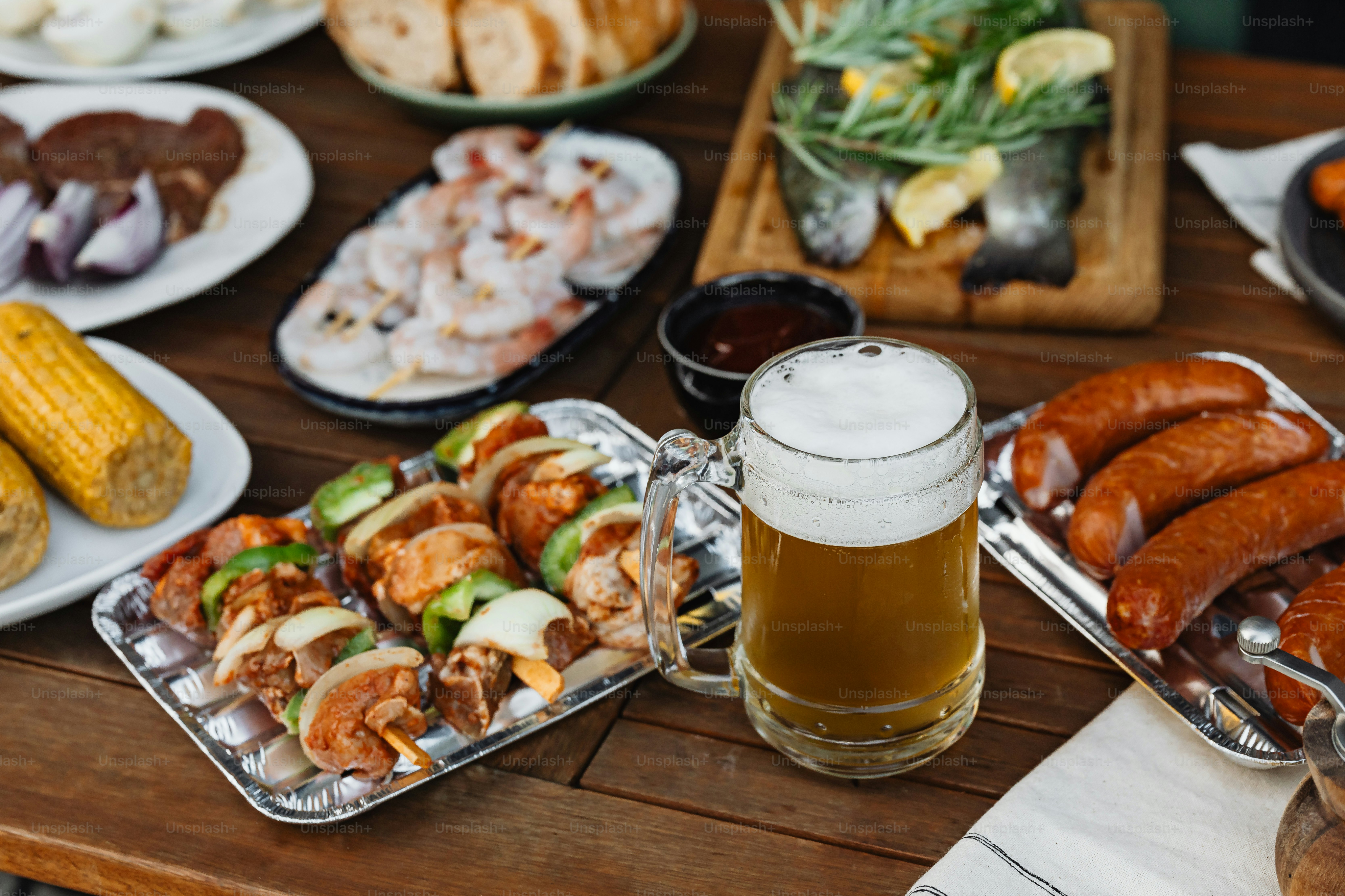 a wooden table topped with plates of food and drinks