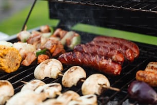 a close up of food on a grill with mushrooms