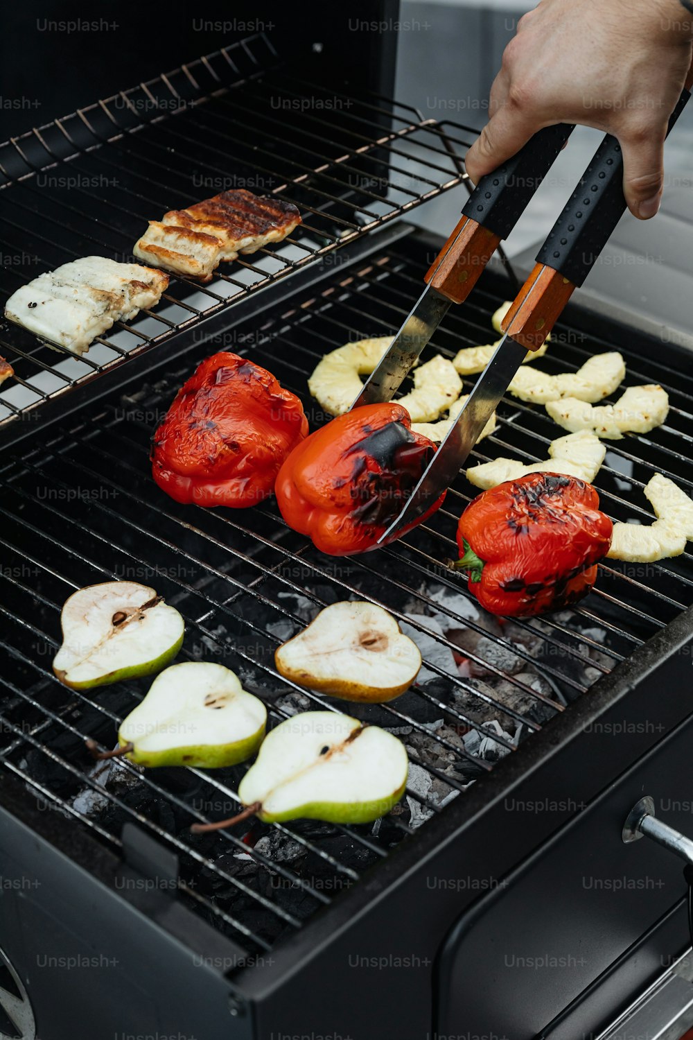 a person is cooking food on a grill