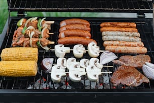 a bbq grill filled with meat and vegetables
