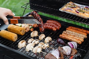 a person using a knife to cut up food on a grill