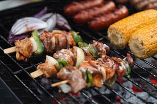 a close up of food on a grill with corn