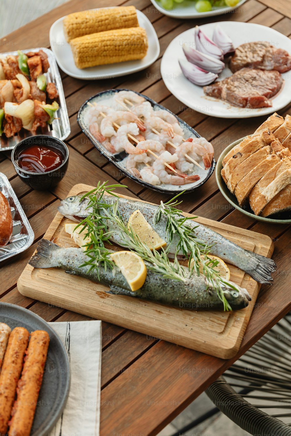 a wooden table topped with plates of food