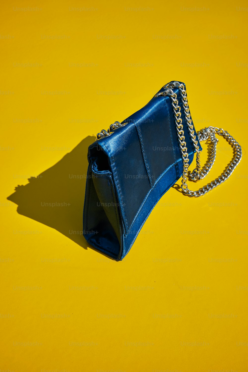 a blue purse sitting on top of a yellow table
