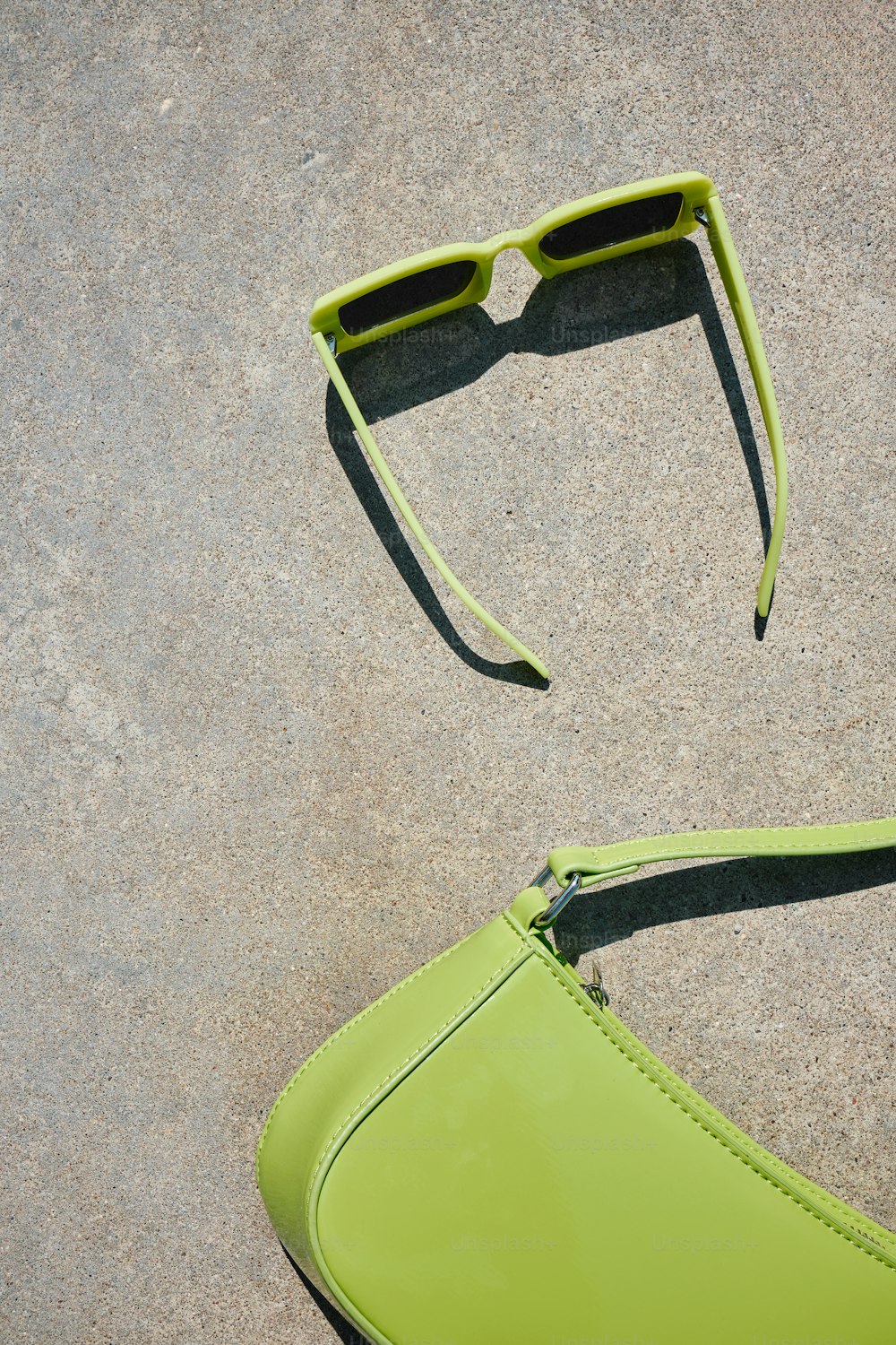 a pair of neon green sunglasses laying on the ground