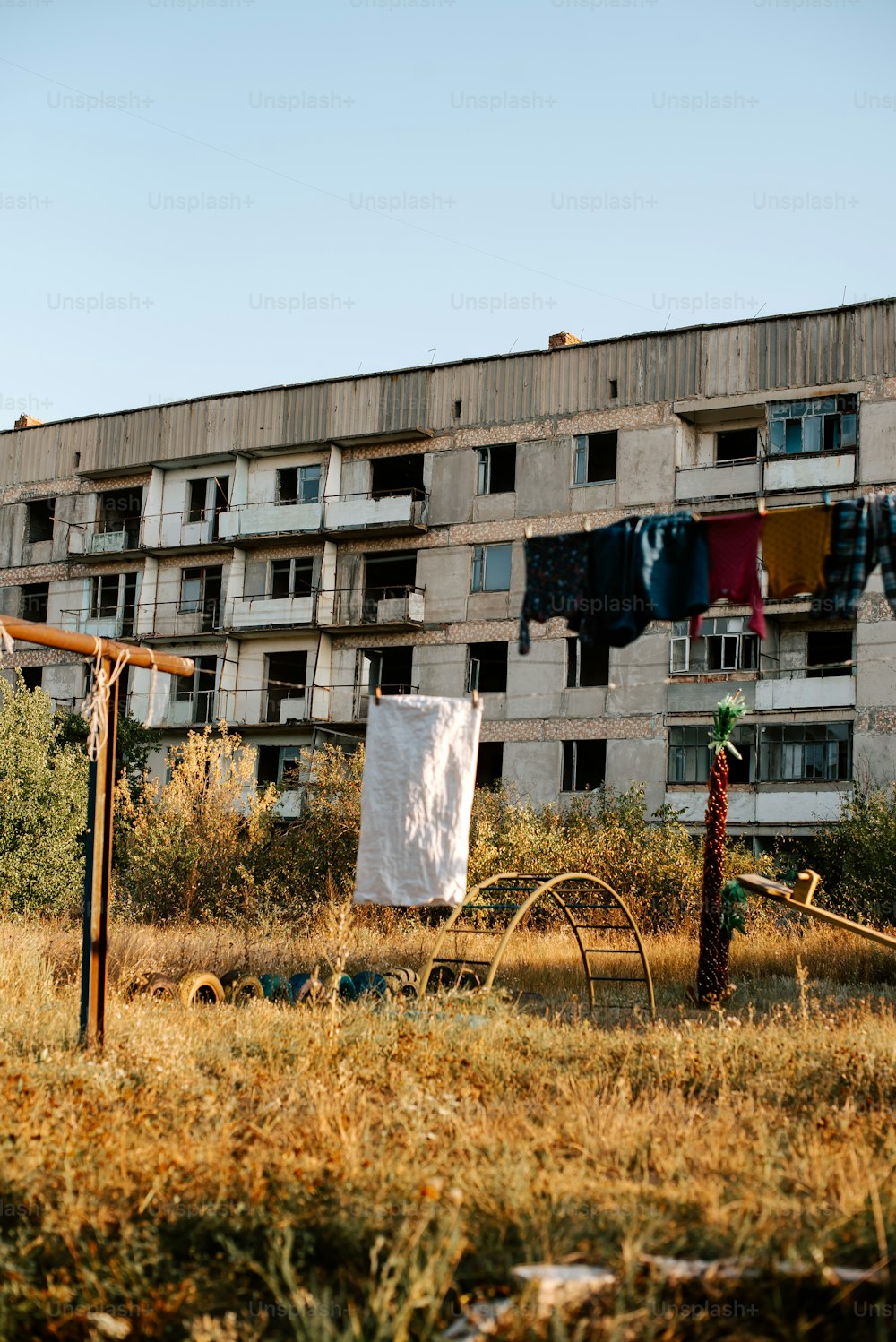an abandoned building with clothes hanging out to dry