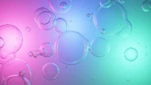 Un gruppo di bolle che galleggiano su uno sfondo blu e rosa