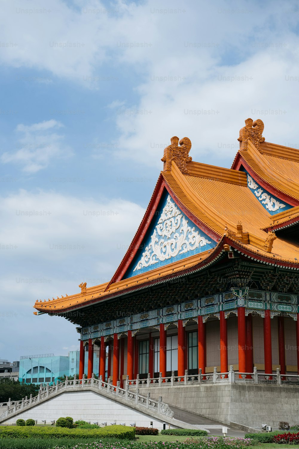 a building with a red roof and blue sky in the background