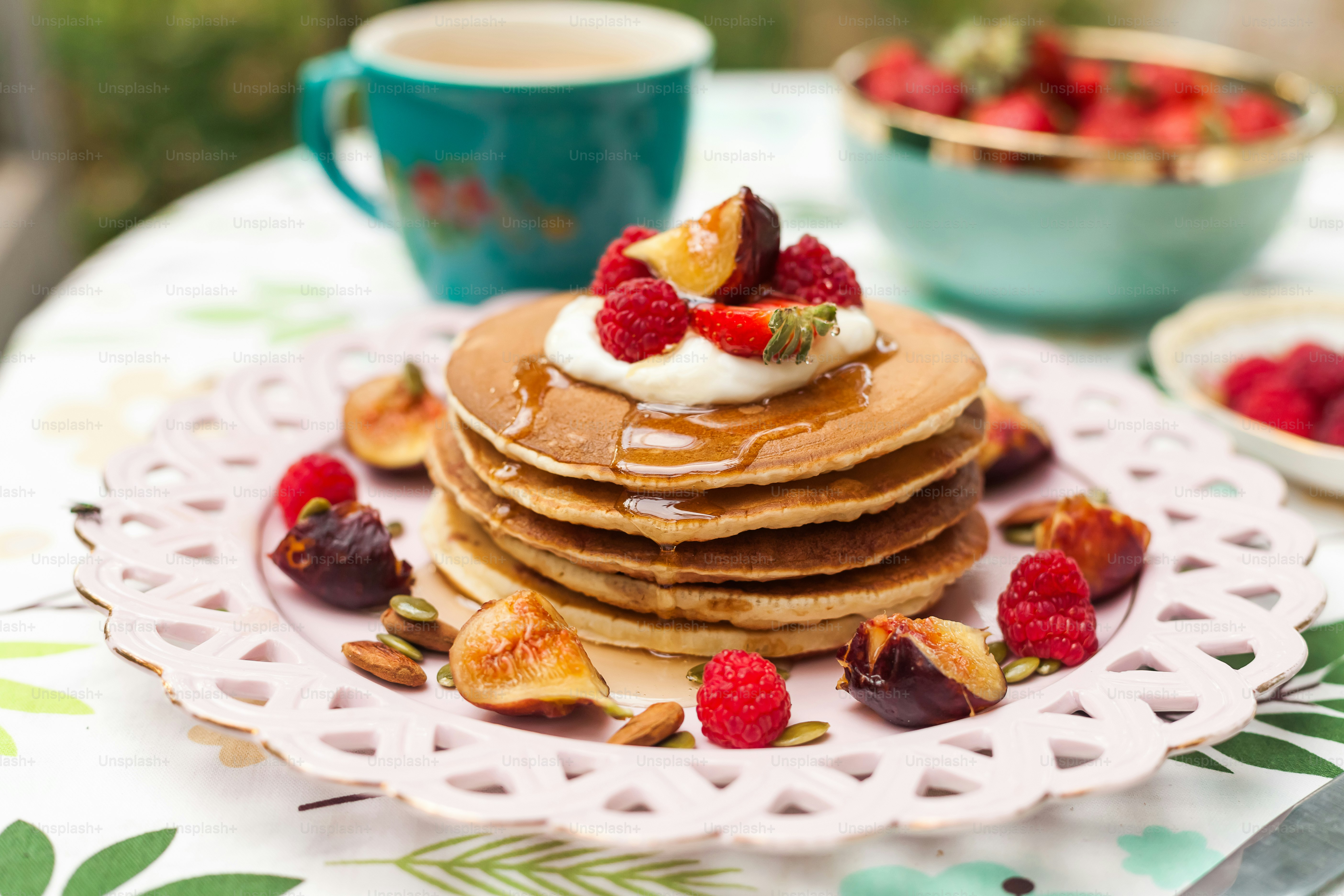 a stack of pancakes with fruit on top